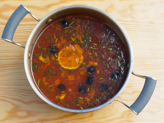 Russian Meat Solyanka Soup In metal Bowl, Top View