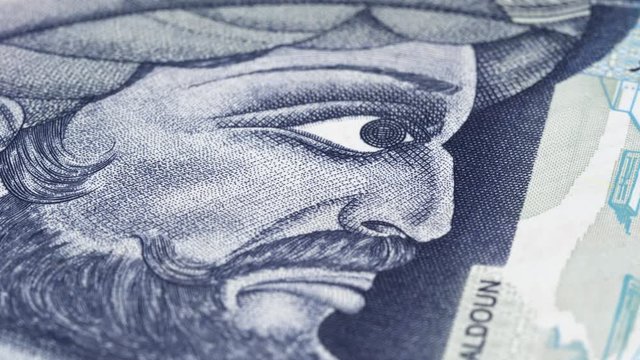 Ibn Khaldun portrait on Tunisia 10 dinars banknote rotating. Greatest Arab historian. Low angle, macro. 4K, 422 10 bit