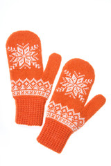 Warm woolen knitted mittens isolated on white background. Orange