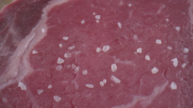 Chef preparing a delicious beef steak in an abstract restaurant scene