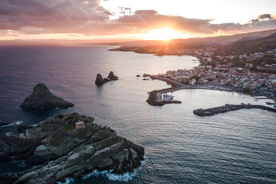 Top view of Aci Trezza, Lachea Island and the Ciclope Stacks at sunset. Sicily, Italy