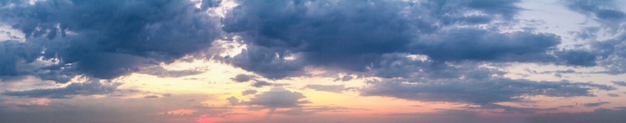 Beautiful summer sunset with a cloudy sky, panorama, banner