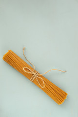 Whole grain spaghetti with complex carbohydrates on a gray background. Healthy food.