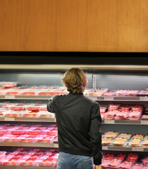 man purchasing a packet of meat at the supermarket	