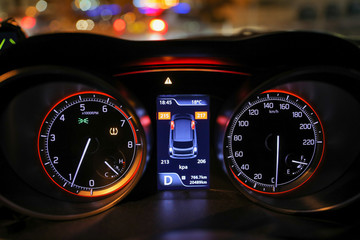 Warning lights flash on the car dashboard. Low tire pressure error sign. 