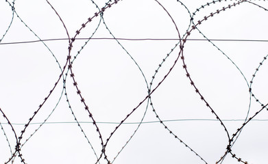 barbed wire on gray sky background