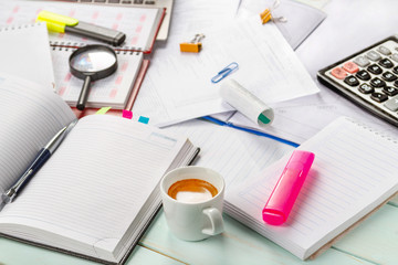 Work with documents. Notebook, pen, notebook, calculator,laptop, financial documents, a cup of cappuccino coffee on the table. Light background.