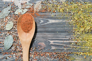 Different seasonings, spices and wooden spoon