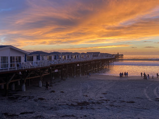 Pacific beach shoreline and pier during colorful sunset., San Diego, California, USA