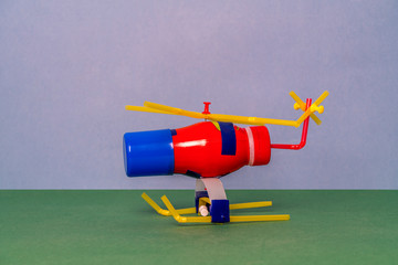 DIY toy helicopter made of waste and plastic bottles. Recycle crafts.