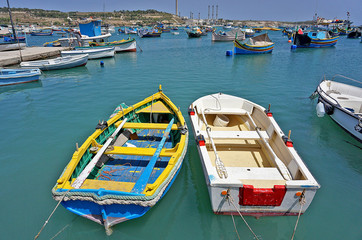 Brightly painted boats, including traditional fishing boats called luzzas which have existed since Phoenician times, bob in Malta’s Marsaxlokk Harbour.