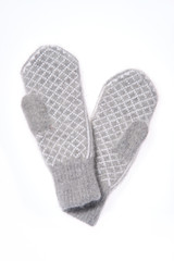 Warm woolen knitted mittens isolated on white background. Gray k
