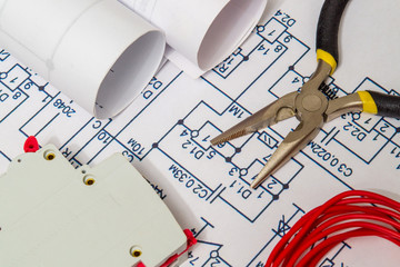 Electrical diagrams and metal pincers building a house concept for engineering projects