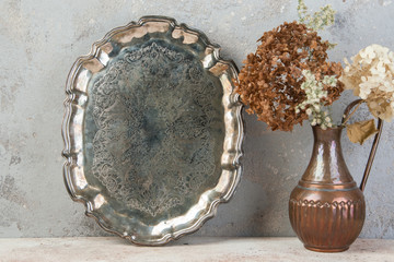 Vintage metal tray on concrete background.