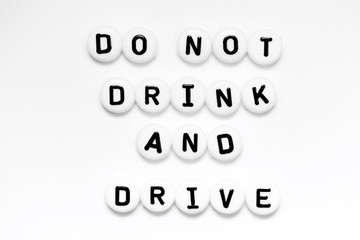 A positive message DO NOT DRINK AND DRIVE written on white circles isolated on a white background...