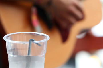 Plastic Cup of Water and Guitar Player