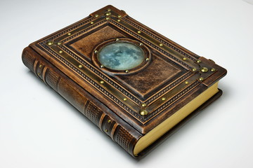 Large leather book with metal frame and the moon picture below thick aged glass.