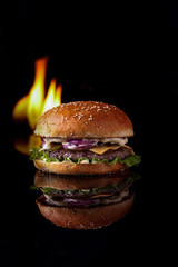  burger with fire on a black background for the site