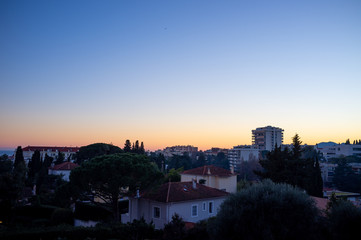 Fototapeta na wymiar view of Cannes, France hill district buildings at sunset