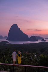 couple watching sunrise over the bay of Phangnga Thailand, men and woman at Samet Nang She...