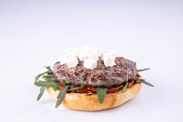  phased assembly of a hamburger on a light background