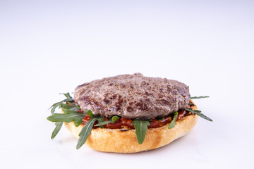  phased assembly of a hamburger on a light background