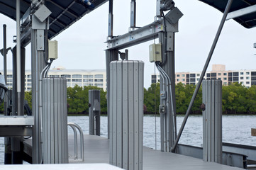 A modern gray boat dock, and pier on bay in bonita springs, florida.