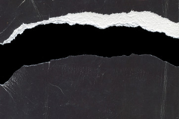texture of torn paper in two on a black background