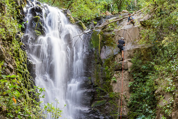 rappelling down a waterfall