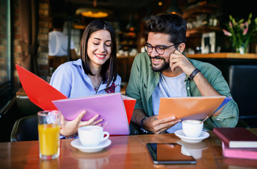 Couple on coffee break. Young students learning in the cafe for seminar. Education, relationships, love concept