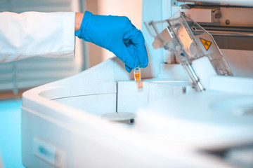 Laboratory equipment, putting sample tube in centrifuge machine 