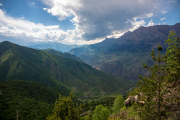 Naklejka na ściany i meble Overcast in mountains. Beautiful mountain rocks in clouds. Landscape of the North Caucasus