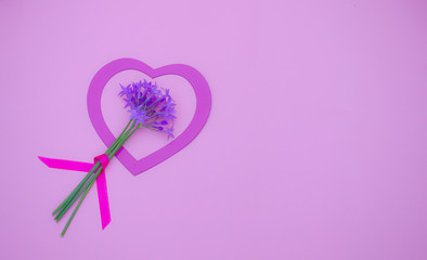 Pink heart with a little flowers bouquet on pastel pink background. Valentines day, Mother day or celebration concept.