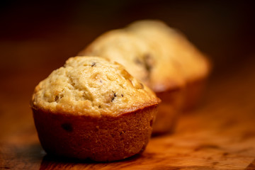Freshly baked muffins on wooden table