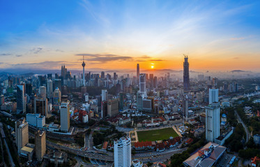 Aerial panoramic view of sunrise over Kuala Lumpur city skyline. 