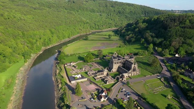 4K aerial footage flying over Tintern Abbey and the Wye River in South Wales in the late afternoon