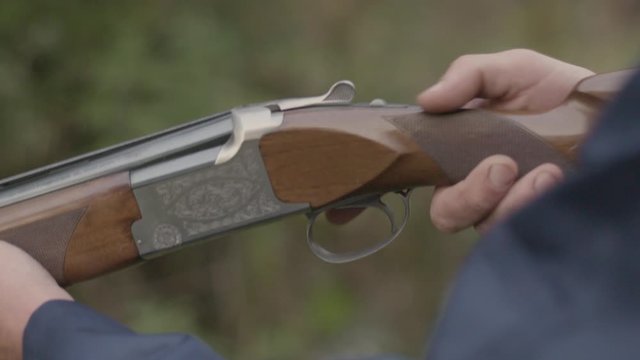 Loading a double barrel over under shotgun and closing the breech