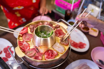 eating pork and beef barbecue with friend
