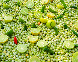 Chillies,limes and peas arranged at a market stall in Kolkata,West Bengal,India.