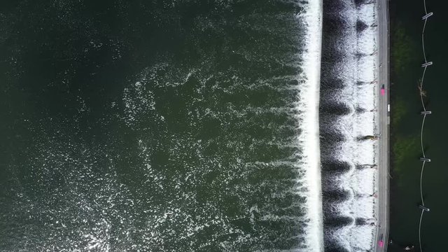 4K aerial descending footage captured directly over the weir on the River Thames at Marlow in Buckinghamshire