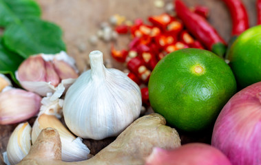Food ingredients, lime, onion and chili on wooden table, asian food cooking concept.