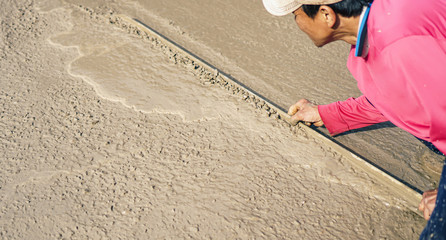 industrial worker Plastering concrete to build floor worker with plastering tools .professional of skilled labor construction industry.selective focus.