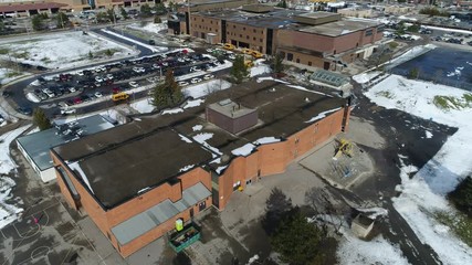 Basketball Courts by Elementary and Highschools With Yellow School Buses Picking Up Students Aerial View - Powered by Adobe