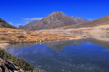 Fototapeta na wymiar alpine landscape and beautiful frozen sela lake in tawang, arunachal pradesh in india