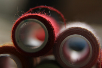 macro-shooting coils with multi-colored threads. close-up of sewing threads