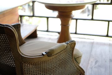 Obraz na płótnie Canvas old vintage wicker rattan chair on terrace balcony. living room interior