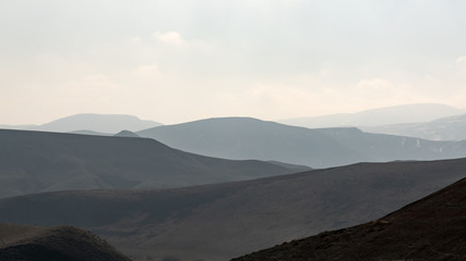 Fototapeta na wymiar Mountain silhouettes in the haze