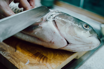 Fresh Fish on Cutting Board in Kitchen