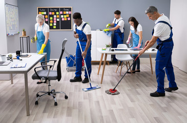 Happy Janitors Cleaning Office