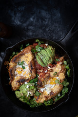 Bake eggs in bread loaves along with avocado, salsa and cheese